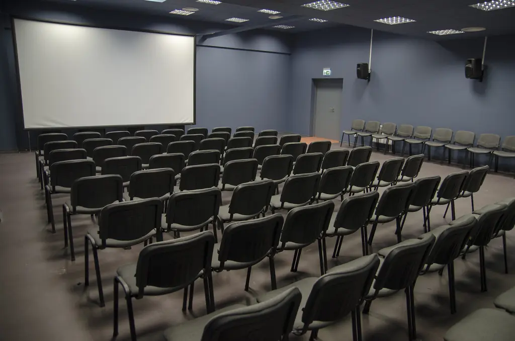 AMII Grey Hall with projection screen and audience seating